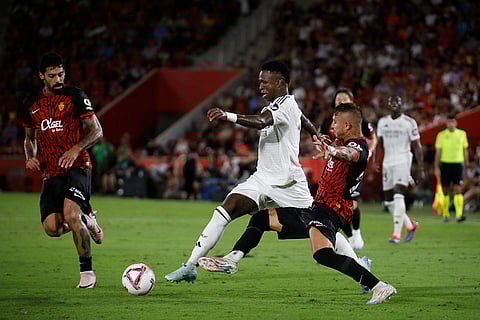 La Liga, Real Madrid vs Mallorca: Real Madrid's Vinicius Junior, centre is challenged by Mallorca's Pablo Maffeo